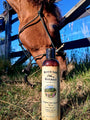 A bottle of Original Skin Repair No. 01 in the grass next to a horse grazing.