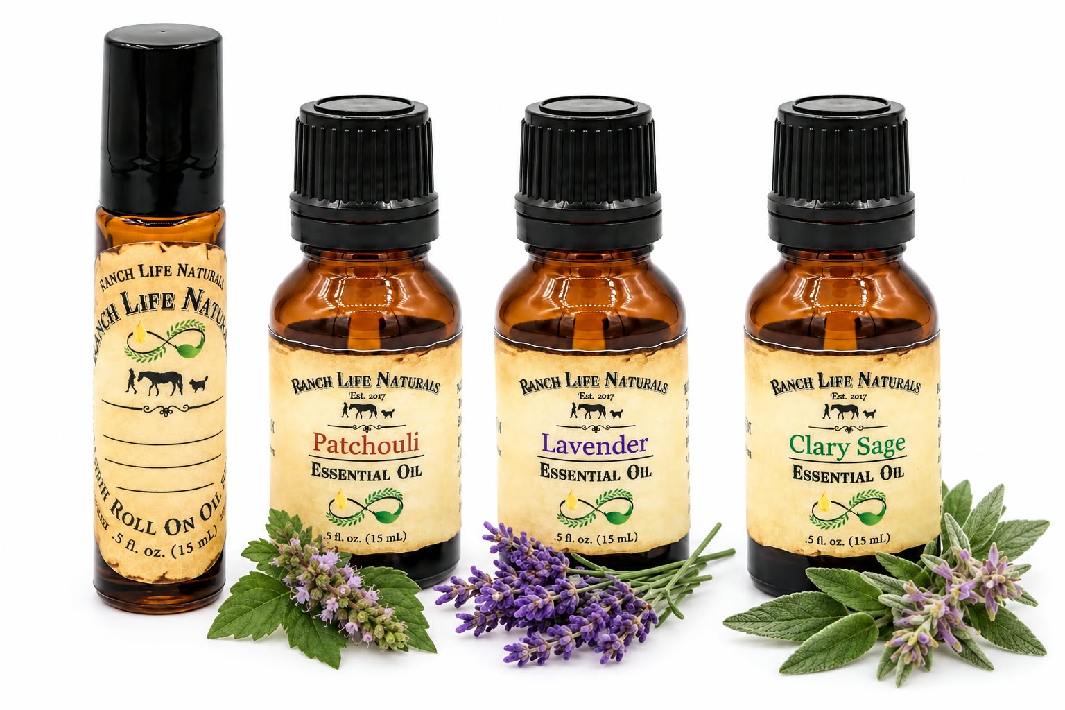 Four amber glass essential oil bottles and one roller-on bottle from Ranch Life Naturals, arranged on a white background with lavender and green herb sprigs in front. The labels read Patchouli, Lavender, Clary Sage, and Roll-On Oil.