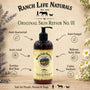A bottle of Ranch Life Naturals Original Skin Repair No. 01 shown on a rustic beige background with decorative flowers and text listing benefits.